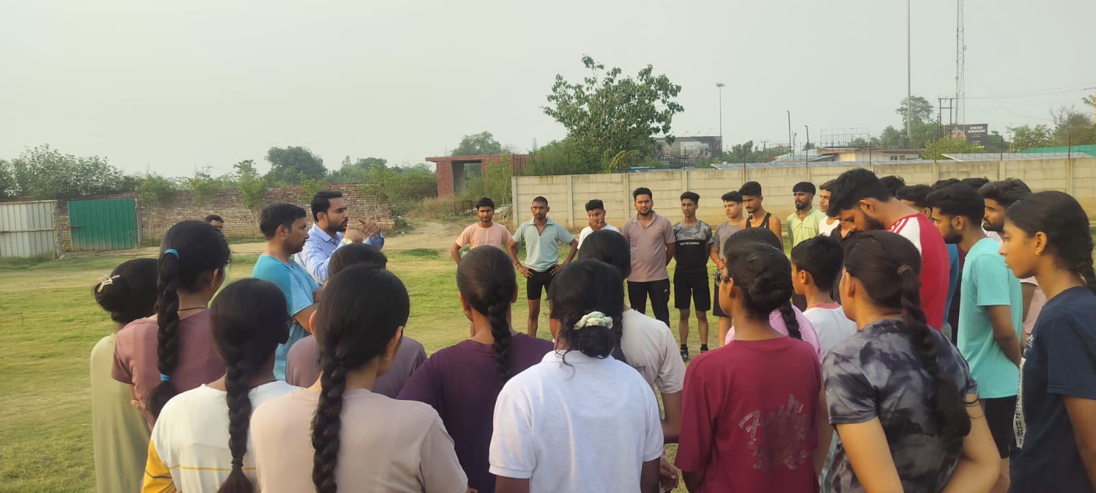 Sports PEFI founder briefing young athletes during an outdoor training session